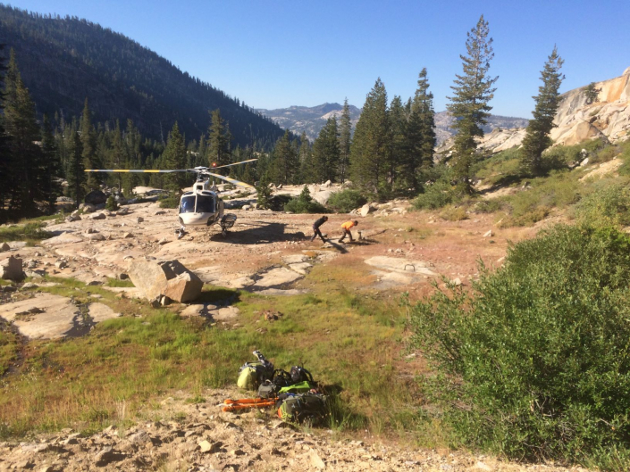 Sequoia staff disembarking a helicopter to start work in the Sierras.